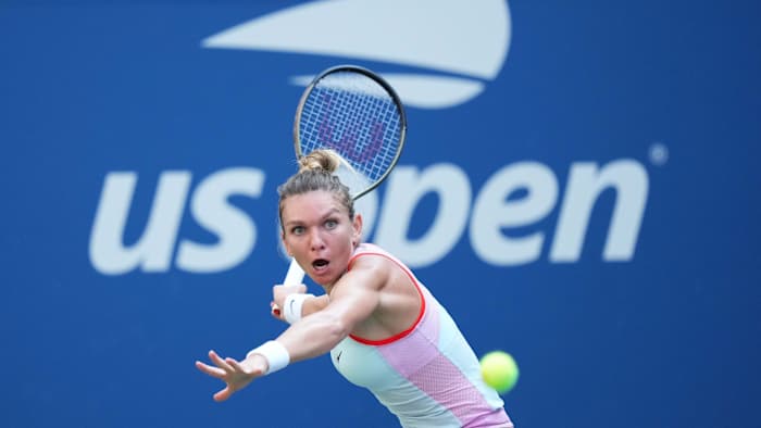 Simona Halep of Romania hits to Daria Snigur of Ukraine on day one of the 2022 U.S. Open.